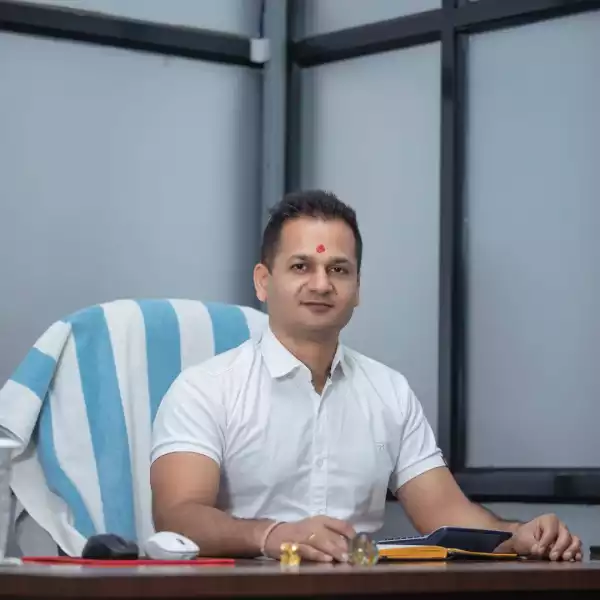 Navraj Bharati, the Managing Director of Manakamana Beverage, sitting in a chair in his office, looking at the camera.